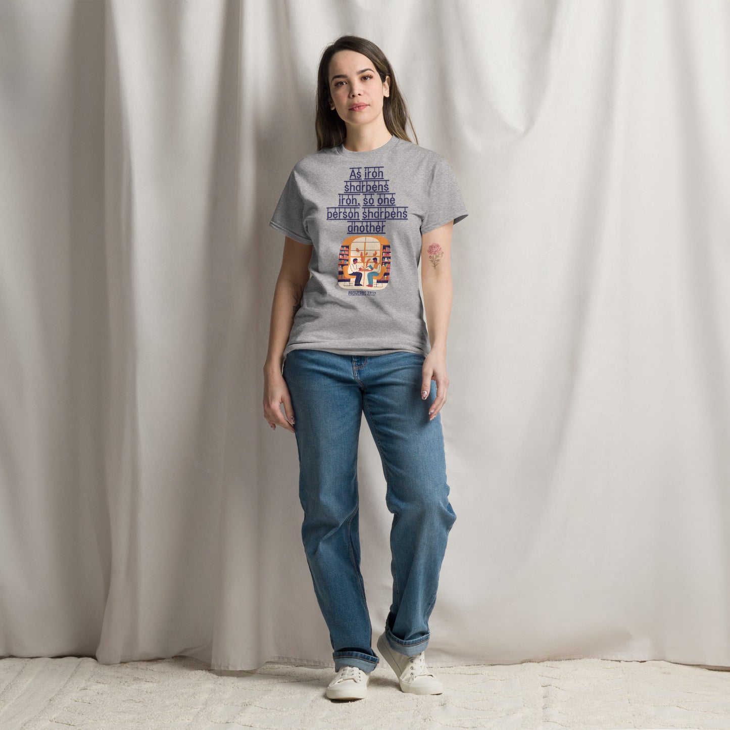 Tees of Worship gray t-shirt with As iron sharpens iron text worn by woman with blue jeans and white sneakers