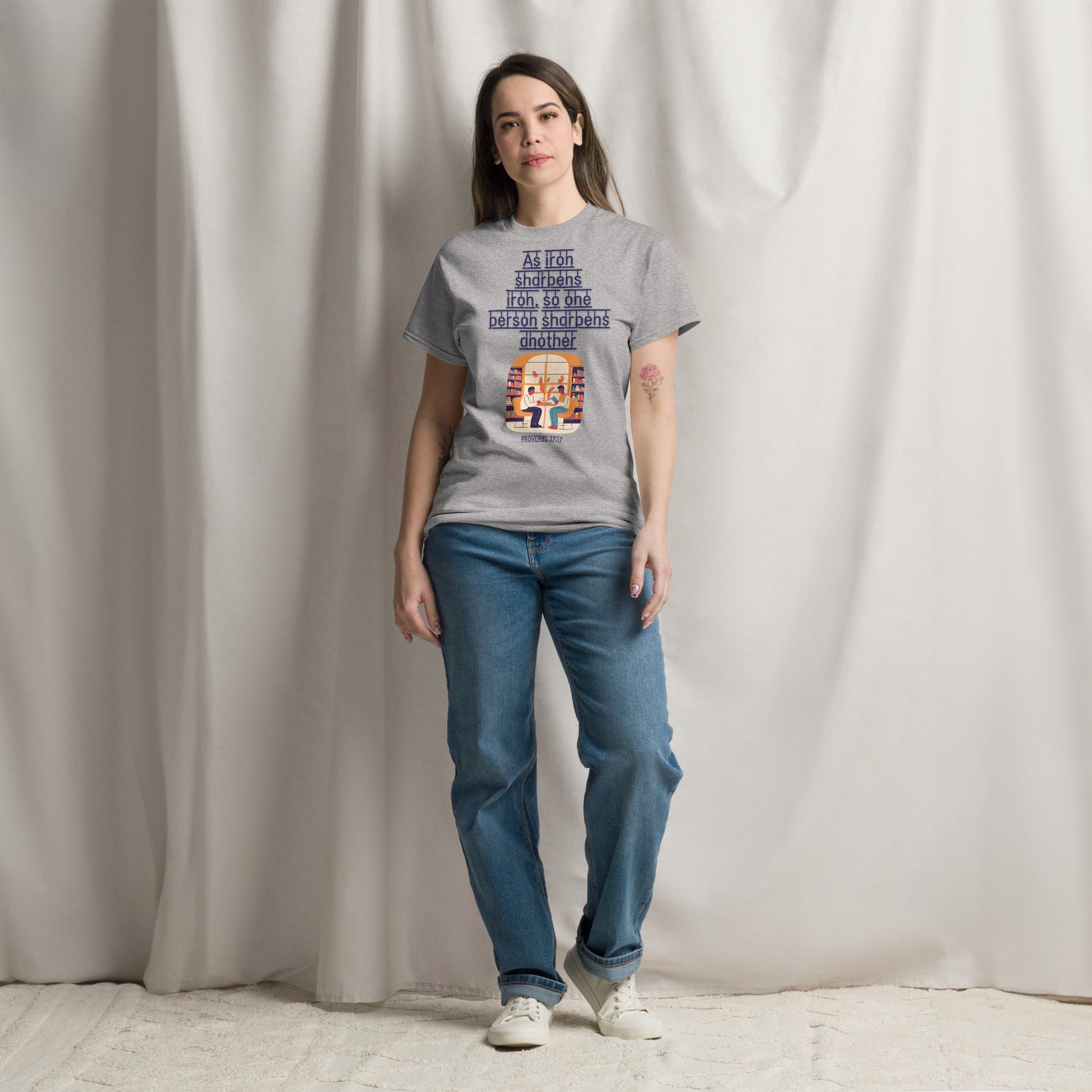 Tees of Worship gray t-shirt with As iron sharpens iron text worn by woman with blue jeans and white sneakers