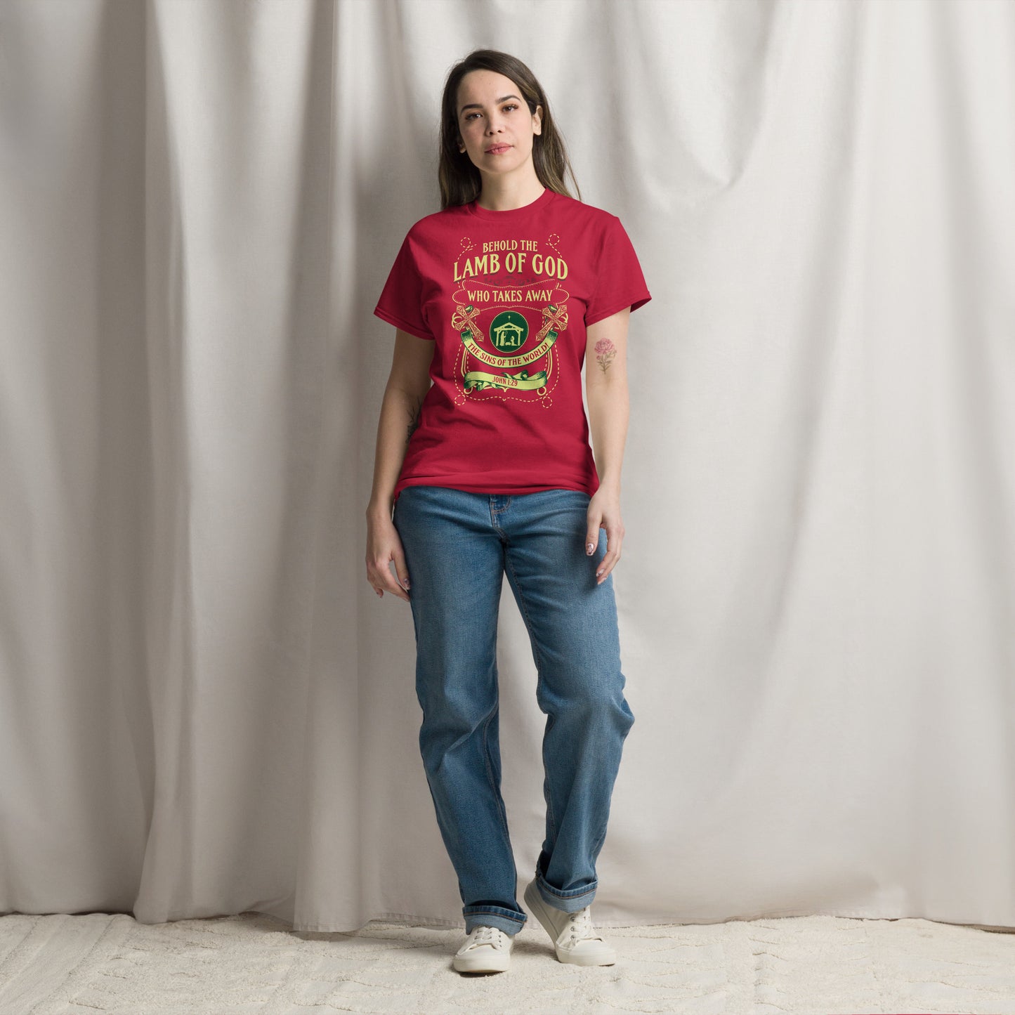 Woman wearing red Behold the Lamb of God T-Shirt by Tees of Worship paired with blue jeans and white sneakers