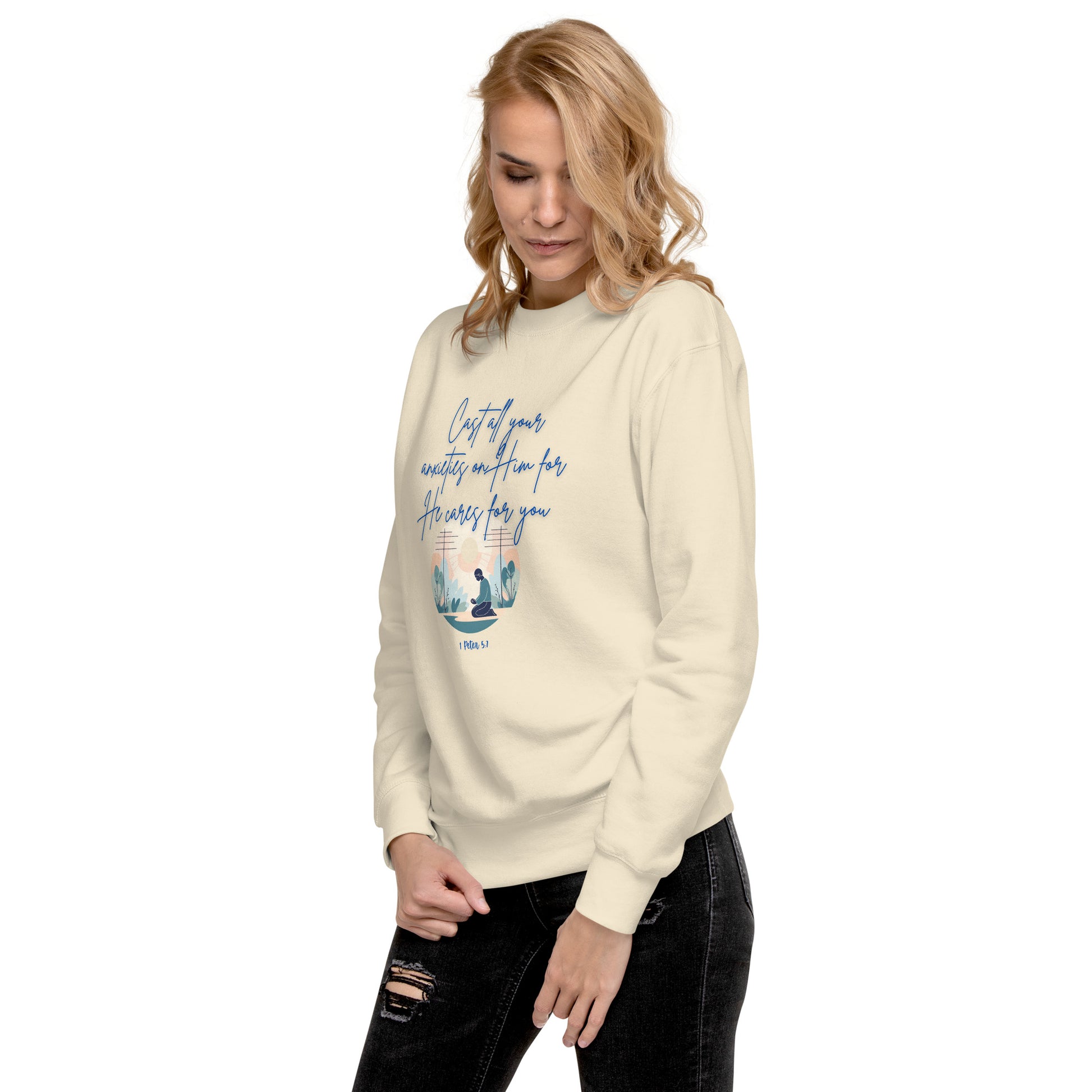 Cream sweatshirt from Tees of Worship with blue text and design saying he cares for you