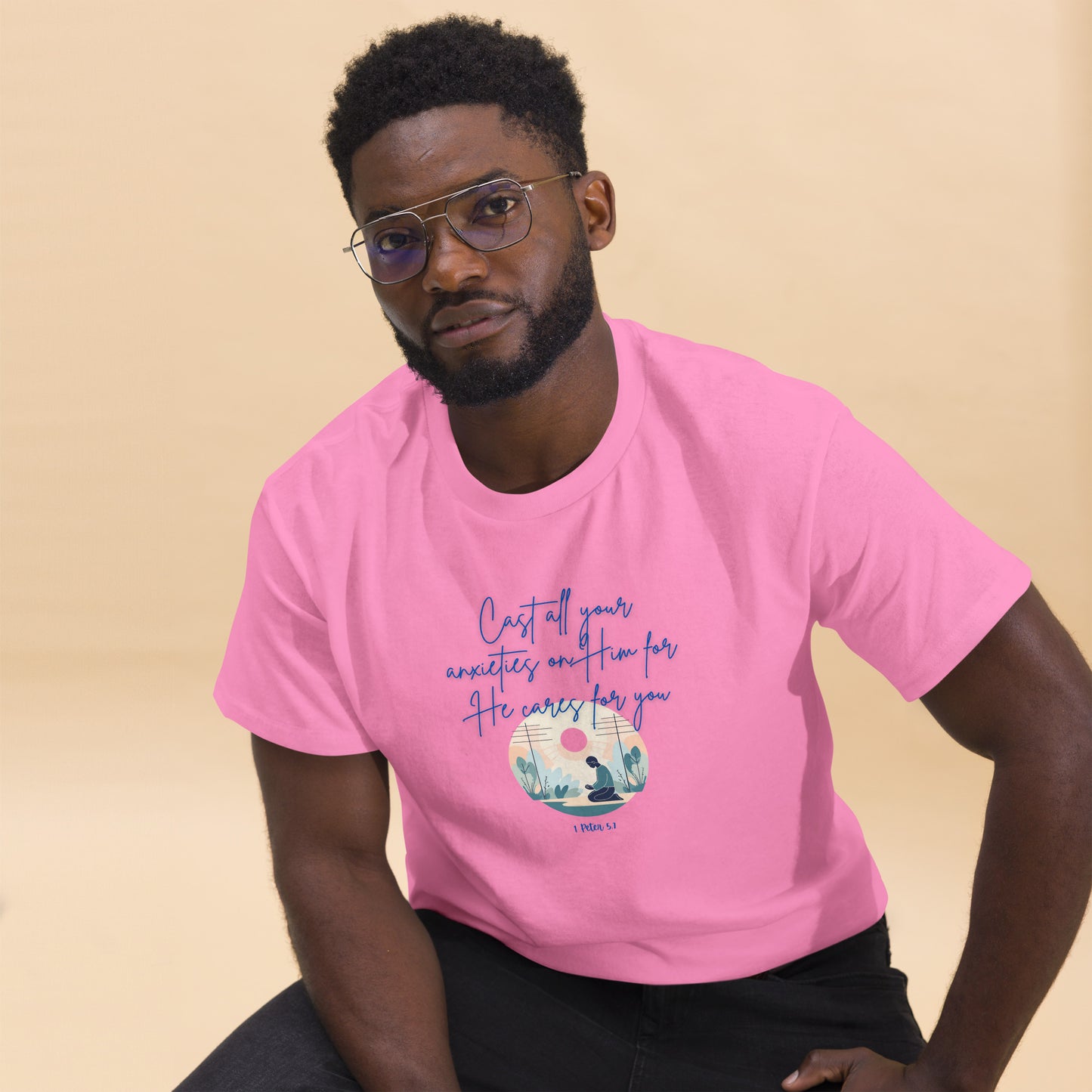 Tees of Worship pink T-shirt with he cares for you scripture design worn by man with glasses