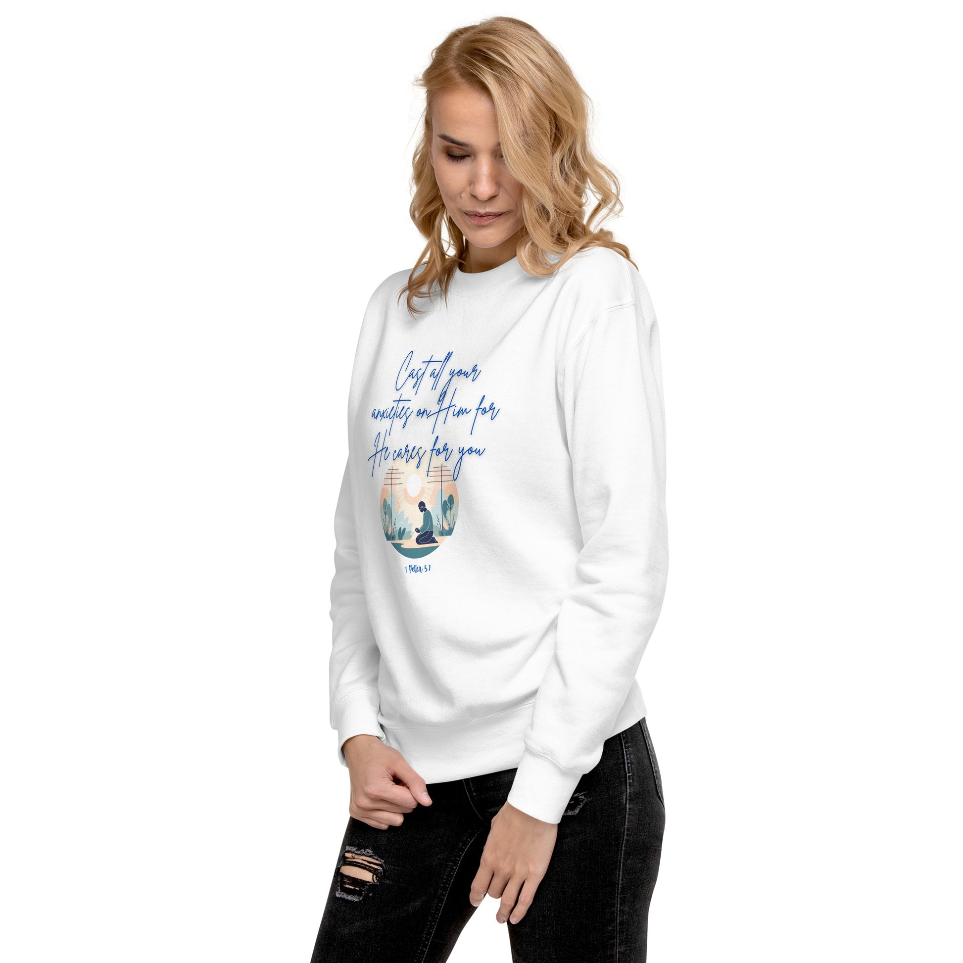 Woman wearing white sweatshirt with blue text and design featuring the phrase he cares for you