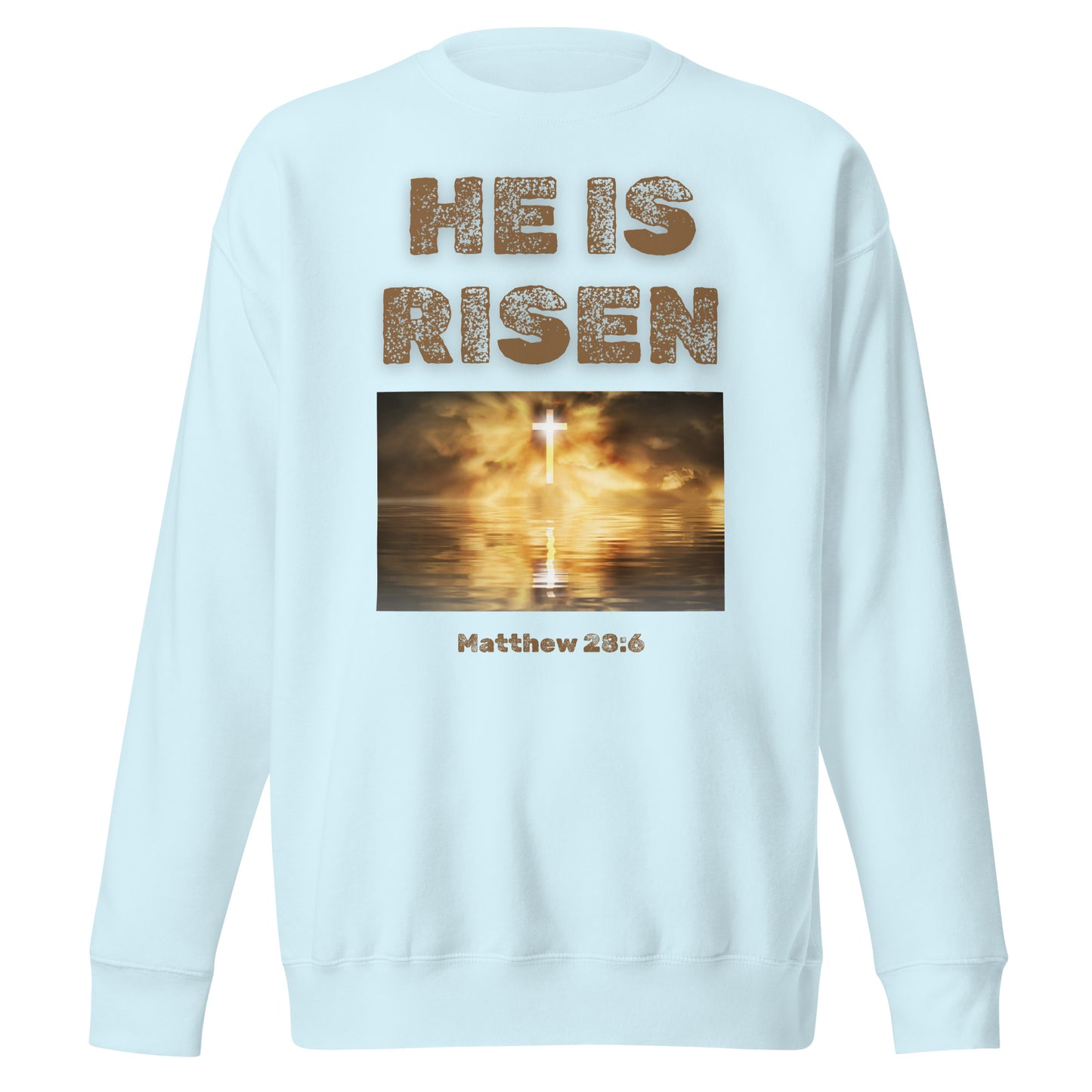Light blue sweatshirt from Tees of Worship with He Is Risen text and glowing cross design