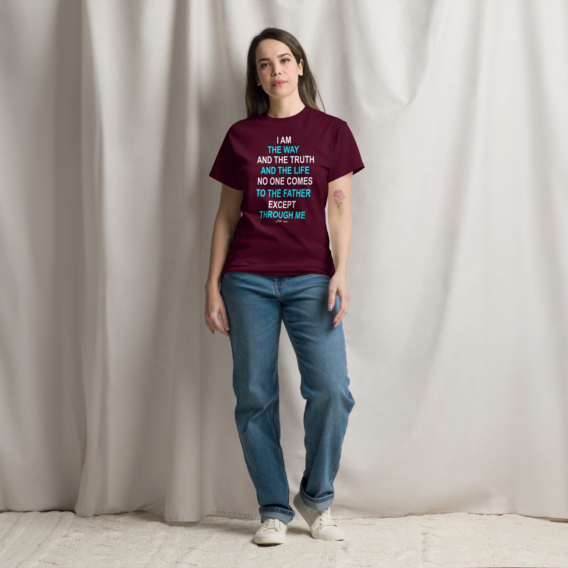 Woman wearing a burgundy Tees of Worship t-shirt with the phrase I am the way printed in colorful text